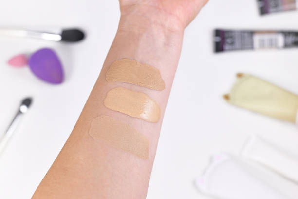 Testing different foundation shades on forearm to find the perfect match for your skin tone.